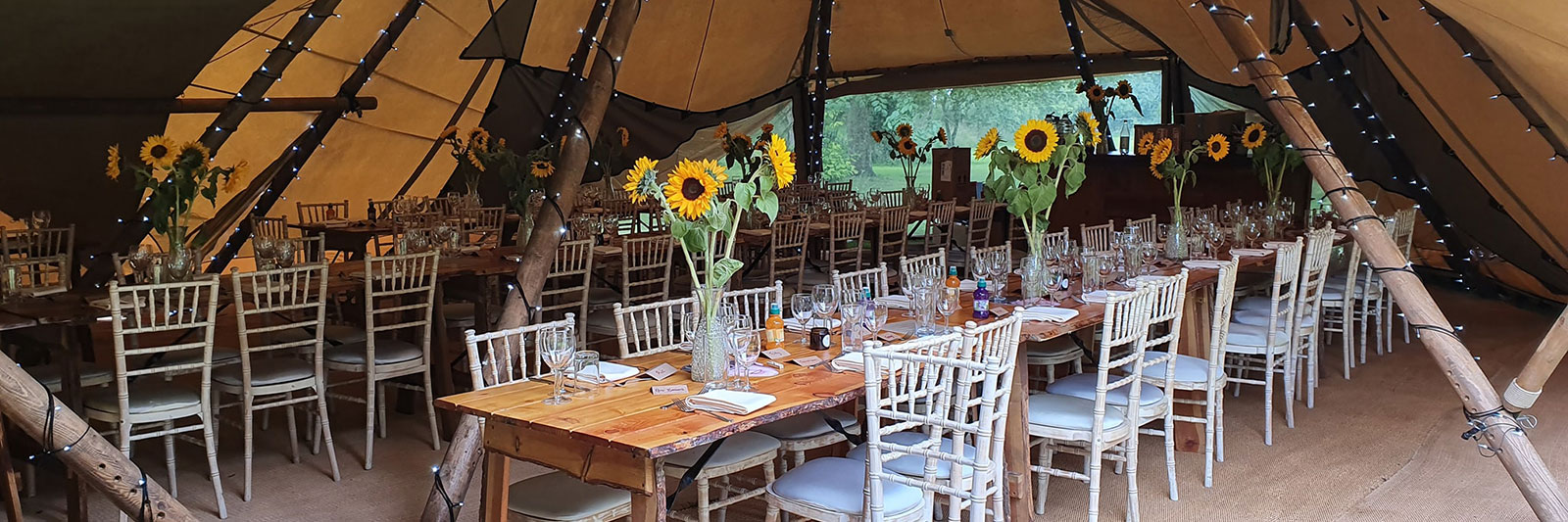 Tables dressed for a function with sunflowers in vases